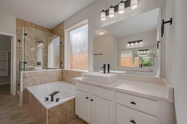 bathroom with vanity and shower with separate bathtub