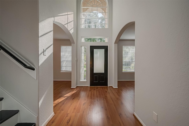 entryway with light wood-type flooring and a high ceiling