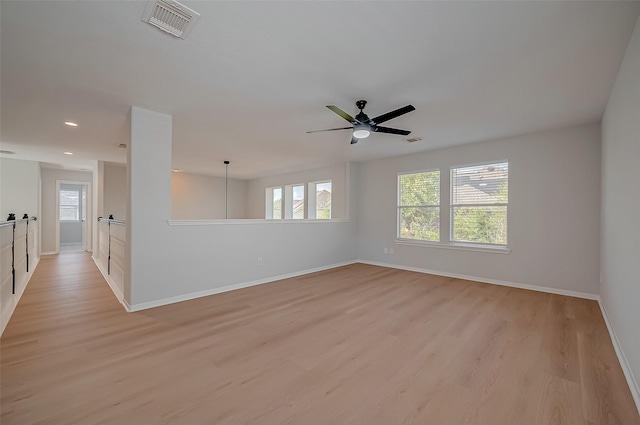 spare room featuring ceiling fan and light hardwood / wood-style floors