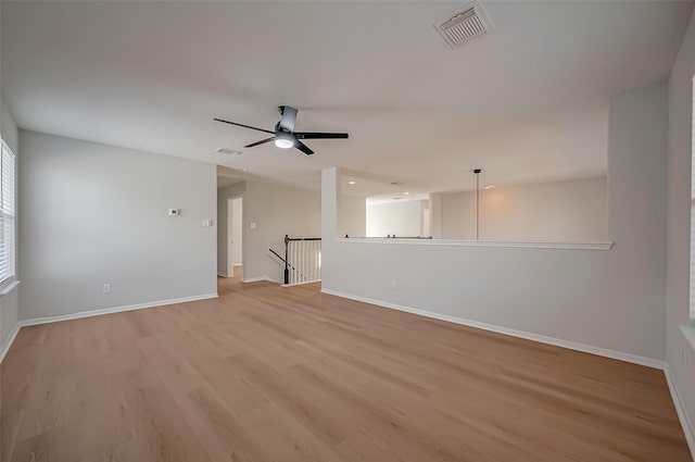 empty room featuring light wood-type flooring and ceiling fan