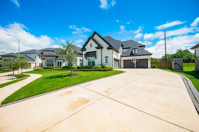 view of front of property featuring stucco siding, concrete driveway, a garage, a residential view, and a front lawn