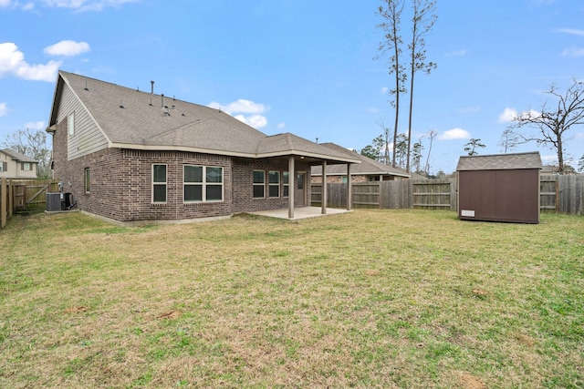 rear view of house featuring brick siding, a storage shed, a patio area, central AC, and an outdoor structure