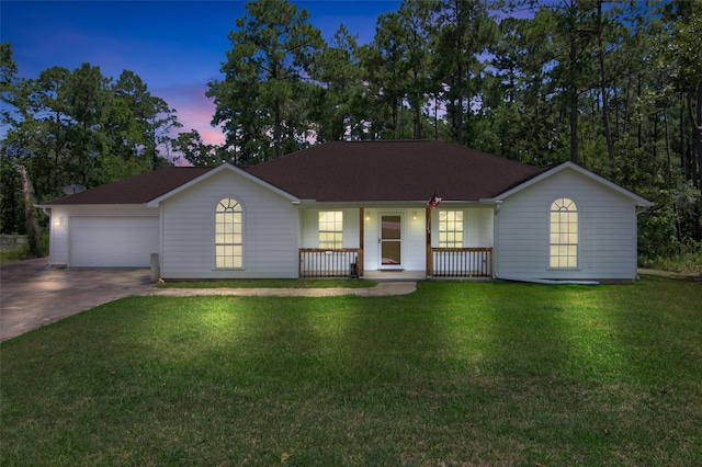 ranch-style home with a garage, a yard, and a porch