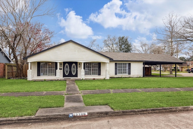 ranch-style home featuring a front yard and a carport