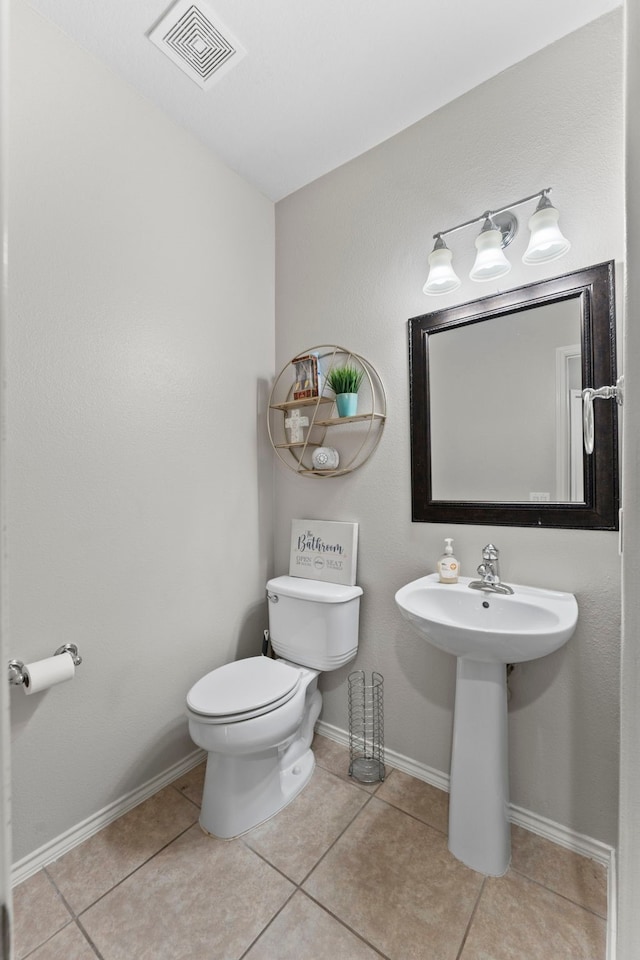 bathroom featuring sink, tile patterned flooring, and toilet