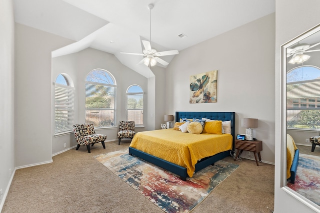 carpeted bedroom with ceiling fan, vaulted ceiling, and multiple windows