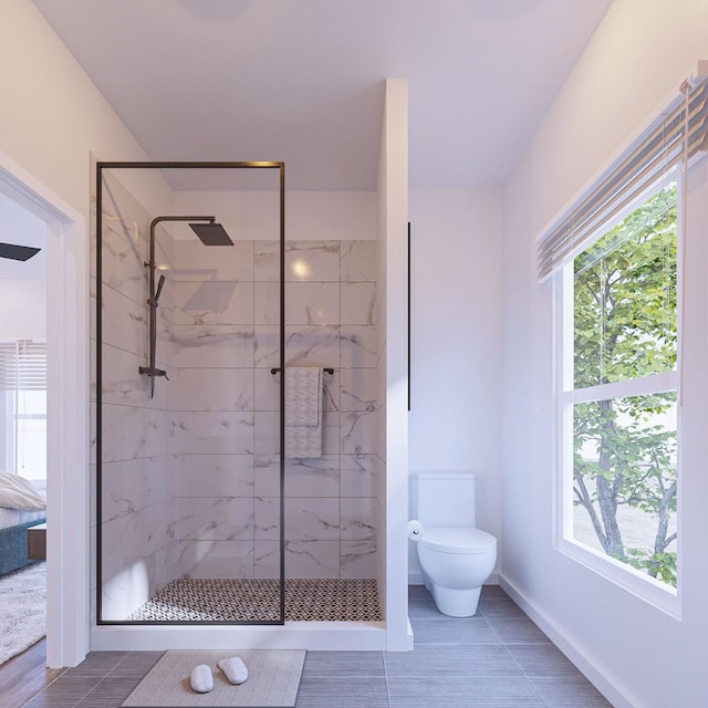 full bath with baseboards, toilet, and a marble finish shower