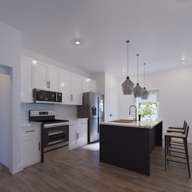 kitchen with decorative light fixtures, a center island with sink, stainless steel appliances, white cabinets, and a sink