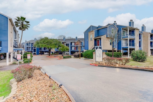 view of road featuring a residential view and curbs