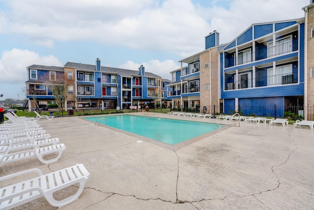 pool featuring a patio area and fence