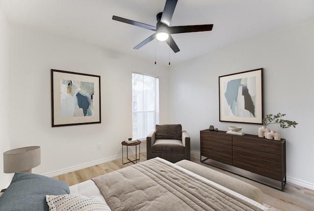 bedroom featuring baseboards, ceiling fan, and light wood-style floors