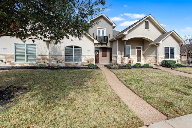 view of front of property with a front yard and a balcony