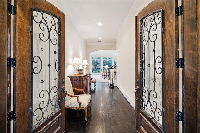 entrance foyer with arched walkways, recessed lighting, ornamental molding, wood finished floors, and baseboards