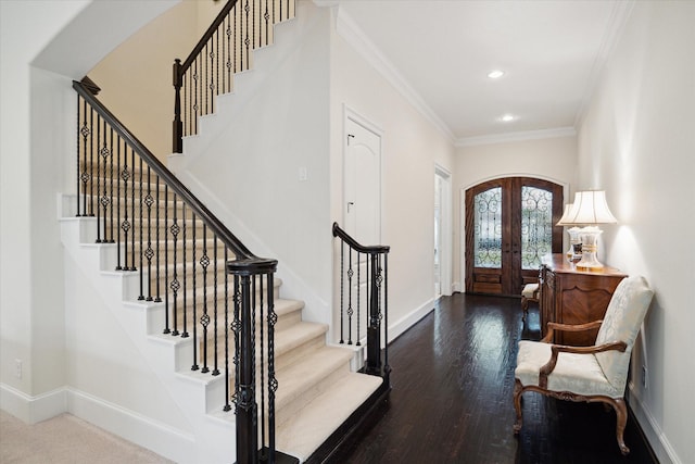 foyer with baseboards, arched walkways, crown molding, and french doors