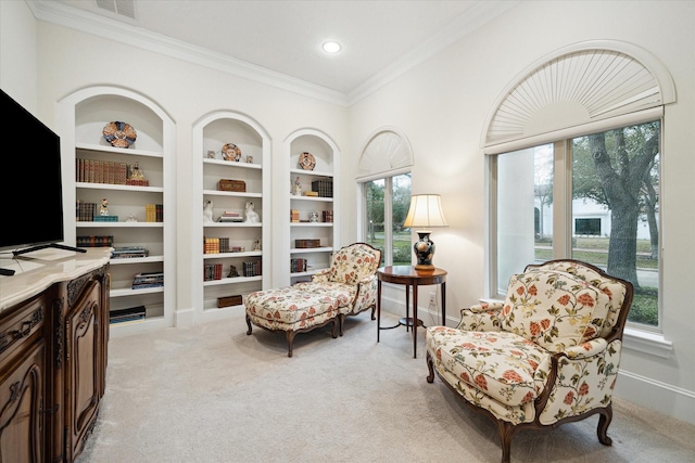 living area featuring baseboards, visible vents, built in features, light colored carpet, and crown molding