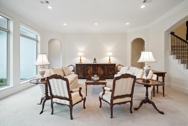 living area with recessed lighting, light colored carpet, and crown molding