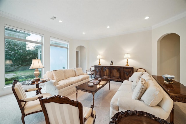 living room featuring light carpet, arched walkways, crown molding, and recessed lighting