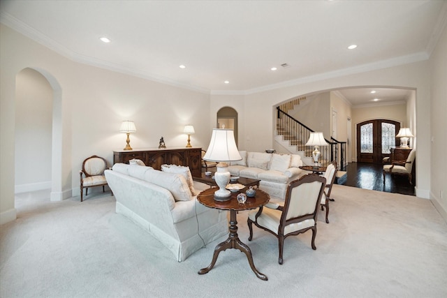 living room featuring arched walkways, french doors, stairway, and baseboards