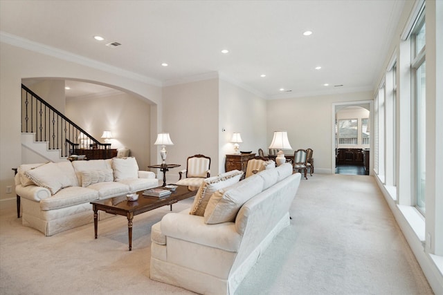 living room featuring visible vents, arched walkways, light colored carpet, ornamental molding, and recessed lighting