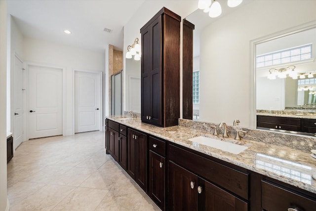 full bath featuring a stall shower, plenty of natural light, and a sink