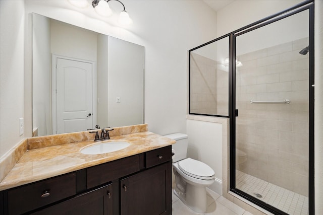 full bath featuring toilet, vanity, a shower stall, and tile patterned floors