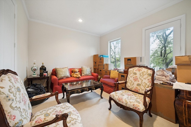 sitting room with recessed lighting, light carpet, and crown molding