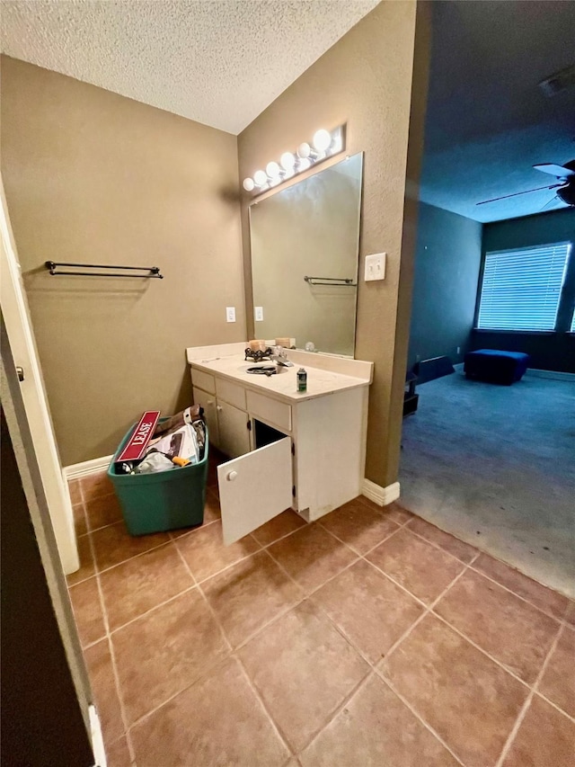 bathroom with vanity, tile patterned flooring, and a textured ceiling