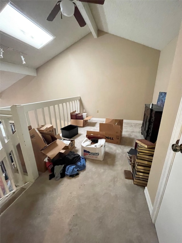 additional living space with ceiling fan and lofted ceiling with beams