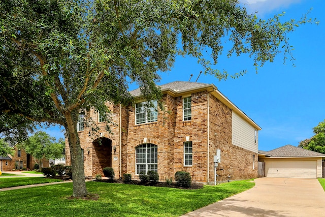 view of front facade with a garage, driveway, a front lawn, and brick siding