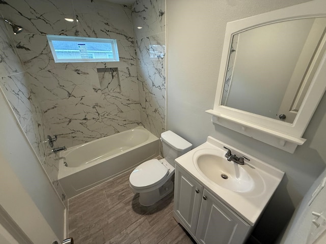 full bathroom featuring toilet, vanity, and tiled shower / bath