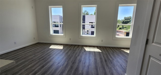 unfurnished room featuring dark wood-type flooring