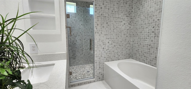 bathroom featuring separate shower and tub and vanity