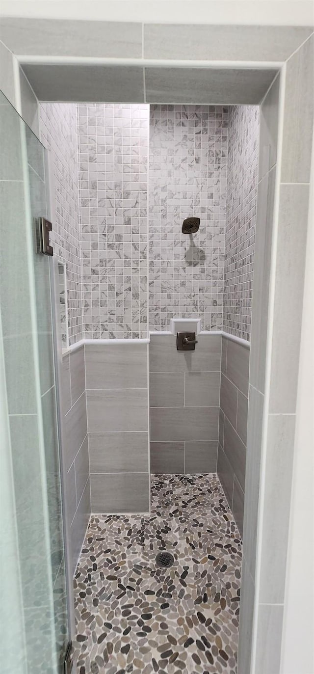 bathroom with a tile shower