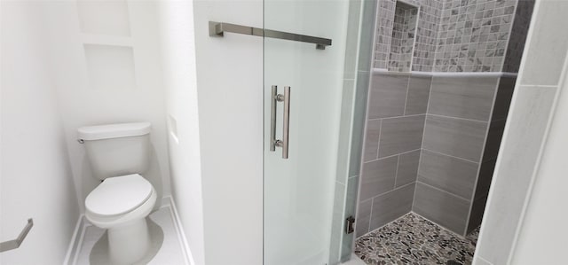 bathroom with toilet and walk in shower