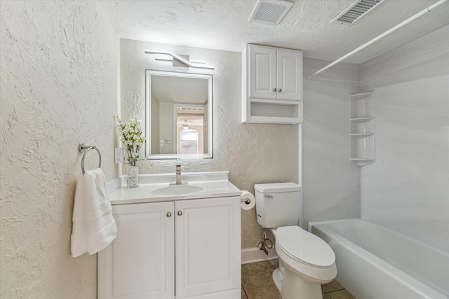 full bath featuring a textured wall, toilet, tile patterned floors, a textured ceiling, and vanity