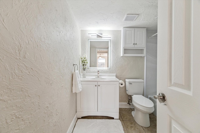 bathroom featuring visible vents, a textured wall, a textured ceiling, vanity, and tile patterned floors