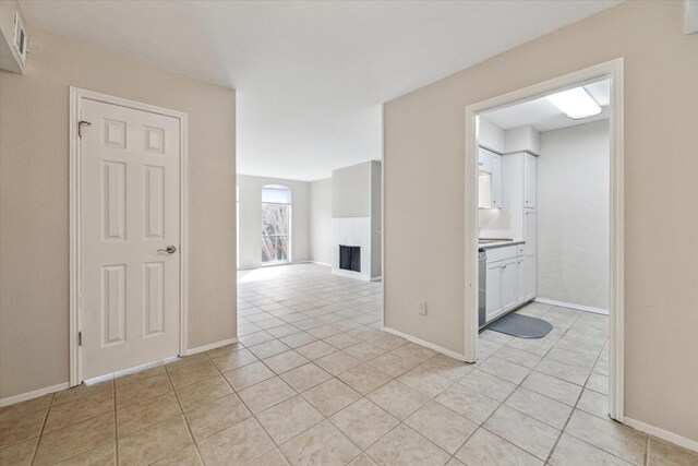 interior space with light tile patterned flooring and baseboards