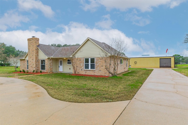 ranch-style house with a front yard, a chimney, concrete driveway, and brick siding