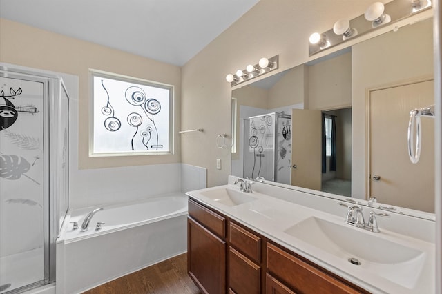 bathroom featuring separate shower and tub, wood-type flooring, and vanity