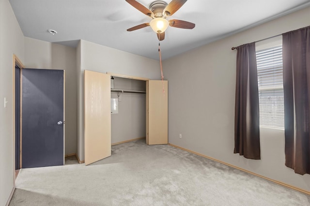 unfurnished bedroom featuring a closet, ceiling fan, and light colored carpet