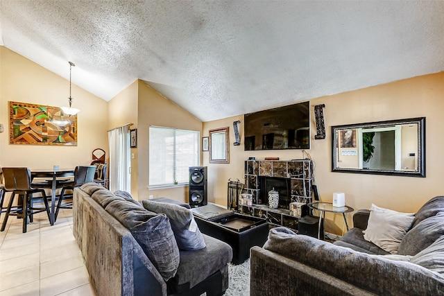 tiled living room with vaulted ceiling, a stone fireplace, and a textured ceiling