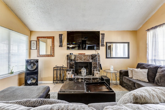 tiled living room with a fireplace, vaulted ceiling, and a textured ceiling