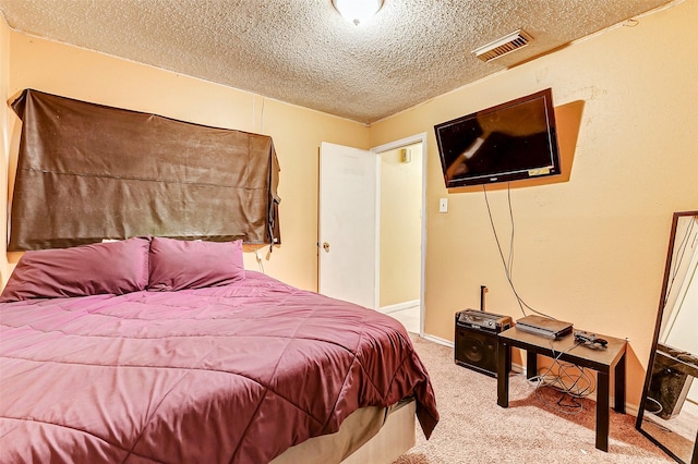 carpeted bedroom featuring a textured ceiling