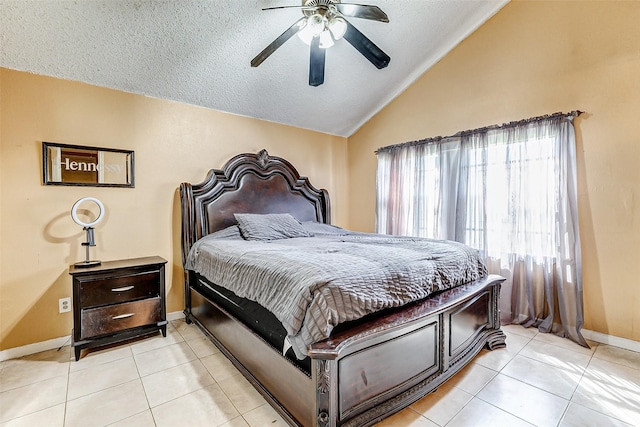 tiled bedroom with vaulted ceiling, ceiling fan, and a textured ceiling