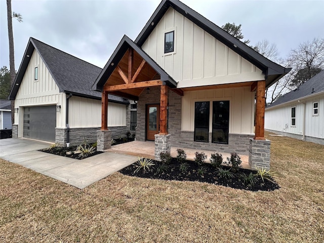 modern inspired farmhouse featuring a garage, stone siding, board and batten siding, and roof with shingles