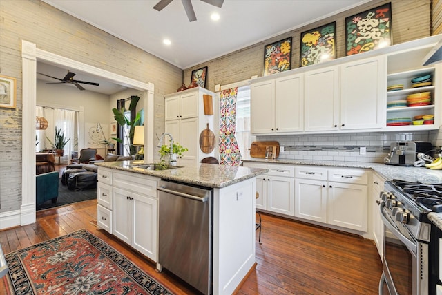 kitchen featuring white cabinets, stainless steel appliances, and light stone countertops