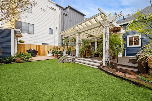 back of property featuring a yard, a pergola, and a wooden deck