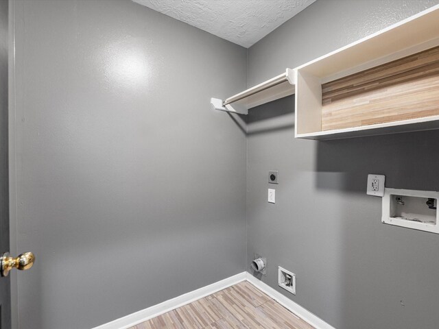 washroom with wood-type flooring, washer hookup, a textured ceiling, and electric dryer hookup