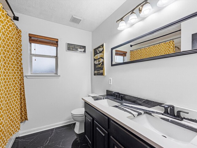 bathroom with a textured ceiling, toilet, vanity, and a shower with shower curtain