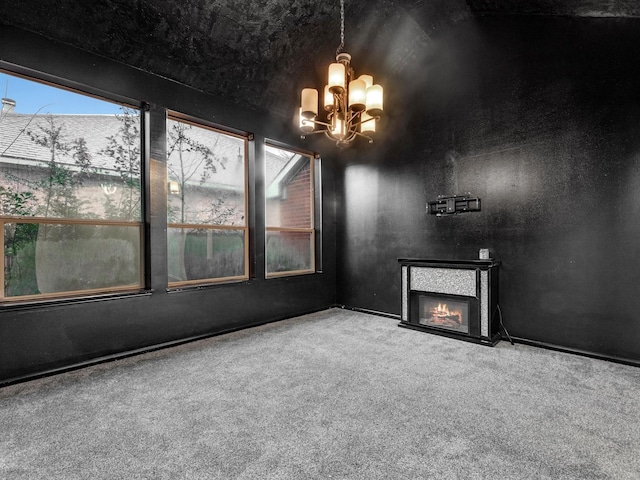 unfurnished living room featuring carpet and an inviting chandelier